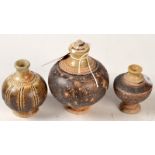 Three Khmer Angkor bottles, one lidded, diameter 11.5cm.