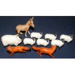 Two small Beswick foxes, one with a tiny chip to its ear,