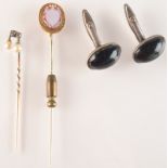 A cameo carved gold mounted hardstone stick pin,