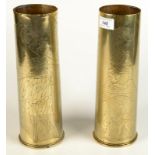 A pair of brass shell case trench art vases with crude engraved decoration, height 29.5cm.