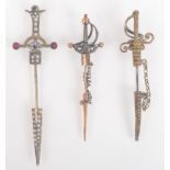 Three sword and scabbard pins.