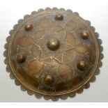 An Indian cast brass dhal shield, diameter 24.8cm.