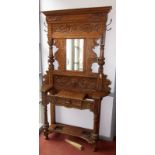 A Victorian oak hall stand carved with leaves,
