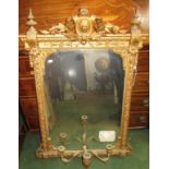 A gilt mirror with three candle branches.