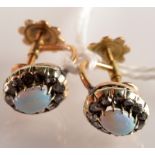 A pair of diamond and opal oval cluster screw on earrings.