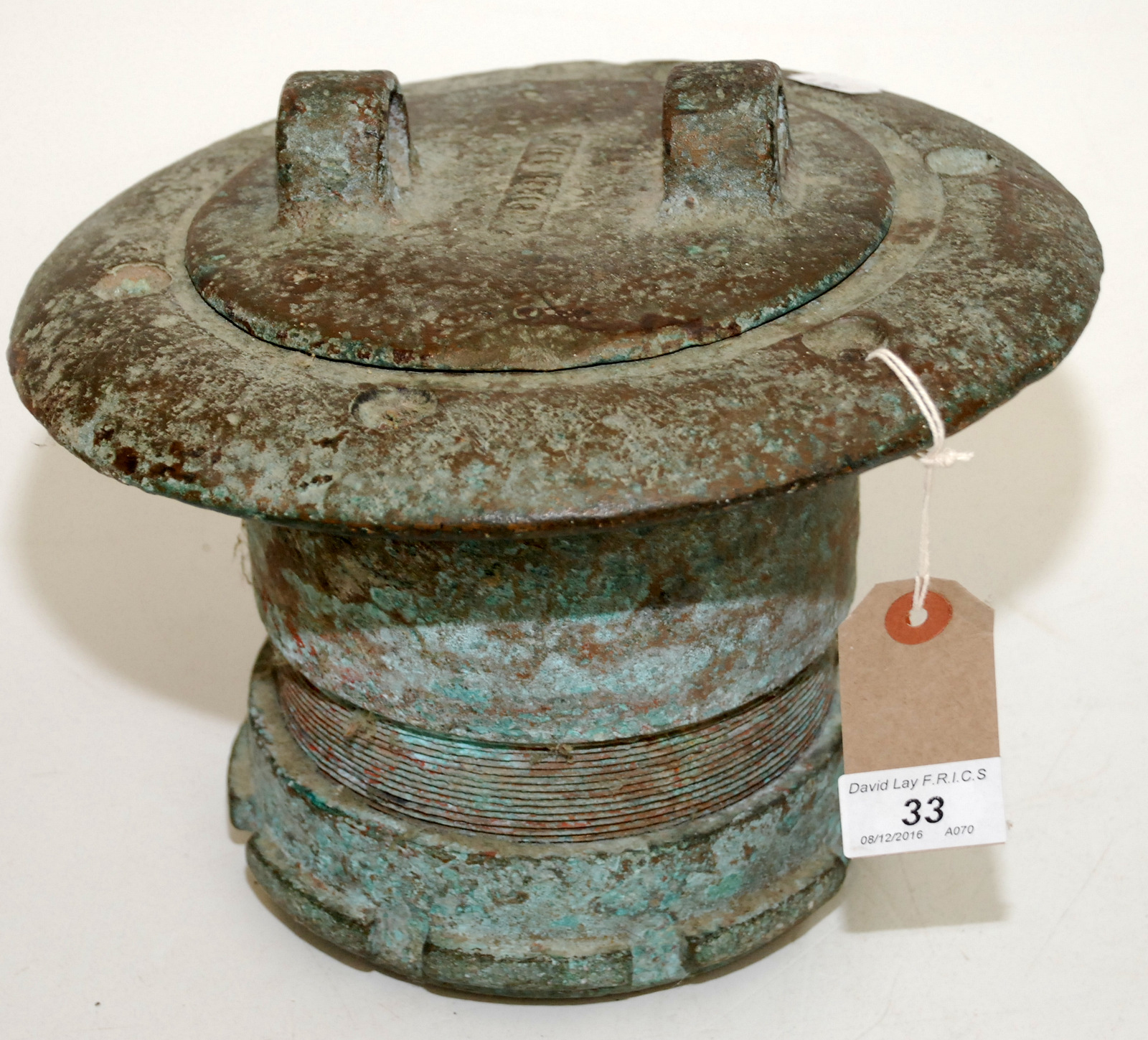 A ship's circular bronze inspection cover, the lid with a pair of lugs, diameter 25.5cm.