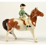 A Beswick girl on a pony, height 14cm. No damage noted.