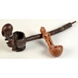 A tribal wooden ladle with figure carved stem, together with an African pipe.