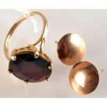 A 9ct. gold dress ring set a red stone and a pair of gold ear studs.