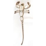 A silver and moonstone scorpion brooch.