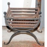 A wrought iron fire basket.