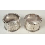 A pair of late Victorian engraved castellated napkin rings.