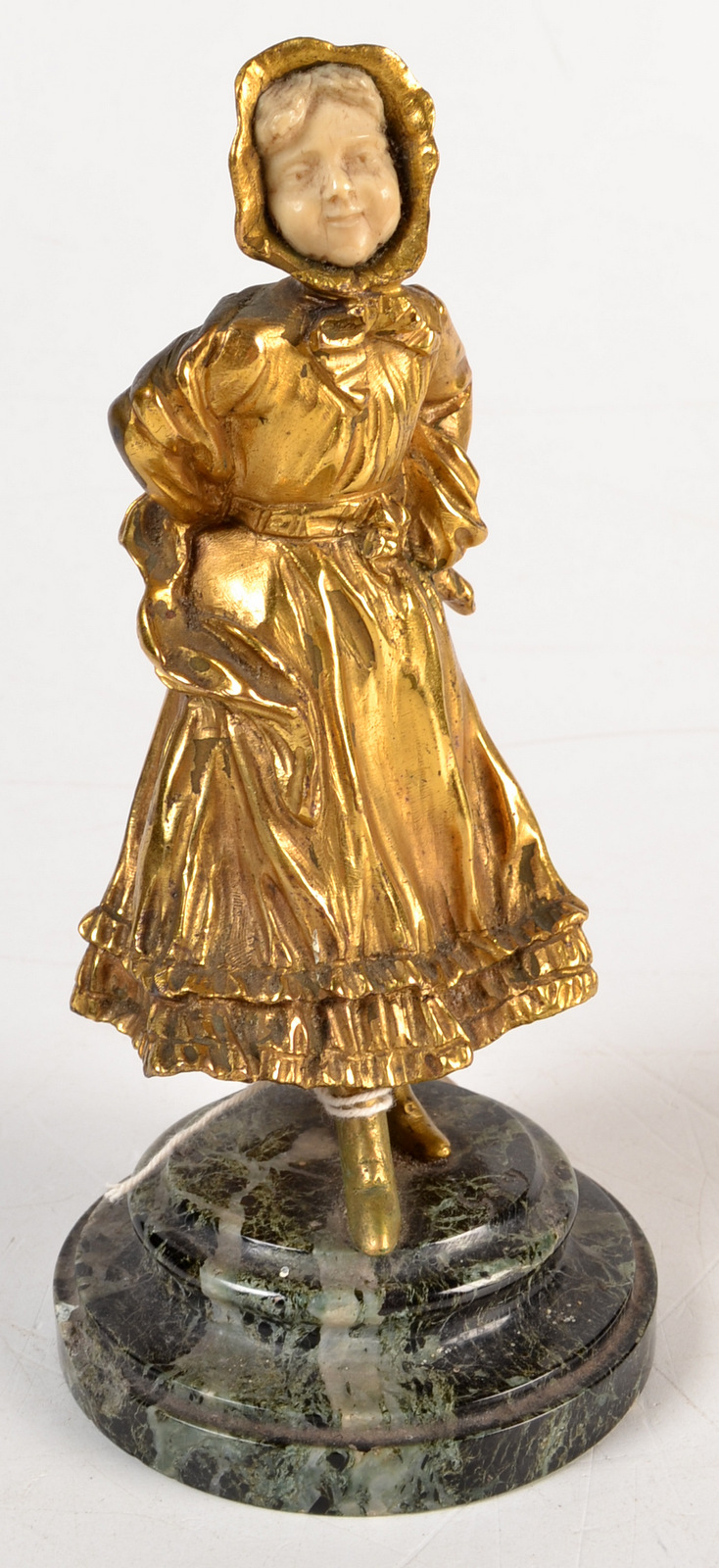 A continental gilt bronze and ivory figure of a girl wearing a bonnet, marble base, height 19cm.