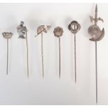 Helmets and crowns, six silver pins.