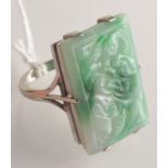 A 9ct. white gold ring set a carved jade panel.