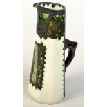 A green Celtic Pottery jug signed to the base "Fisher", height 27cm.