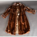 A dark brown, three quarter length mink coat by The Norwich Fur Co., size 10-12.