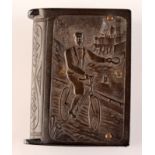 A black vulcanite Vesta case, one side with a lady riding a bicycle, the other a gentleman.