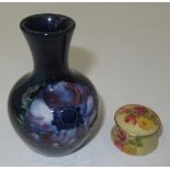A Worcester ivory ground floral painted pomade pot and a small Moorcroft vase.