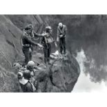 A small collection of glass negatives showing commercial divers working from rocks,