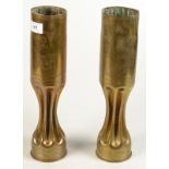 A pair of fluted trench art brass shell case vases, each decorated with a bird, one initialled P,