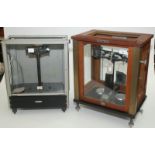 A laboratory balance by W.& J. George & Becker Ltd.in a glazed hardwood case and an Oertling balance