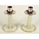 A pair of post war glass candlesticks, each with spiral air stem and silver coloured metal mounts,