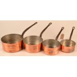 A set of four cylindrical copper graduated pans newly tinned and with iron handles.