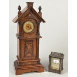 A continental mantle clock in the form of a longcase clock.