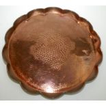 A J F Pool, Hayle, circular copper tray engraved with fish about a planished centre, shaped rim,