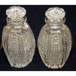 A pair of hexagonal section barrel shape small decanters or toilet bottles,