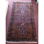 A Belouch rug, the beige field with a large blue central medallion, all with figures of people,