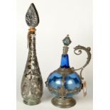 Two pewter mounted decanters.