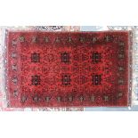 An Iranian rug the madder field with six indigo medallions,