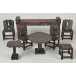 A set of Chinese carved stone miniature furniture, comprising of an altar table, four chairs,