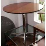 A 1960s/70s circular dining table with a smoked glass top on a chrome pedestal, diameter 122cm.