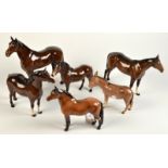 A collection of five Beswick horses and a donkey, leg damage to one.