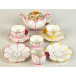 Two Aynsley teacups each with butterfly handle, one pink,