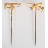 A gold riding crop and horses leg, high purity pin, and a gold hunting crop and stirrup pin.