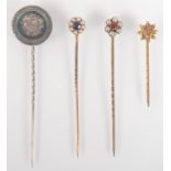 A gold flower head stick pin,