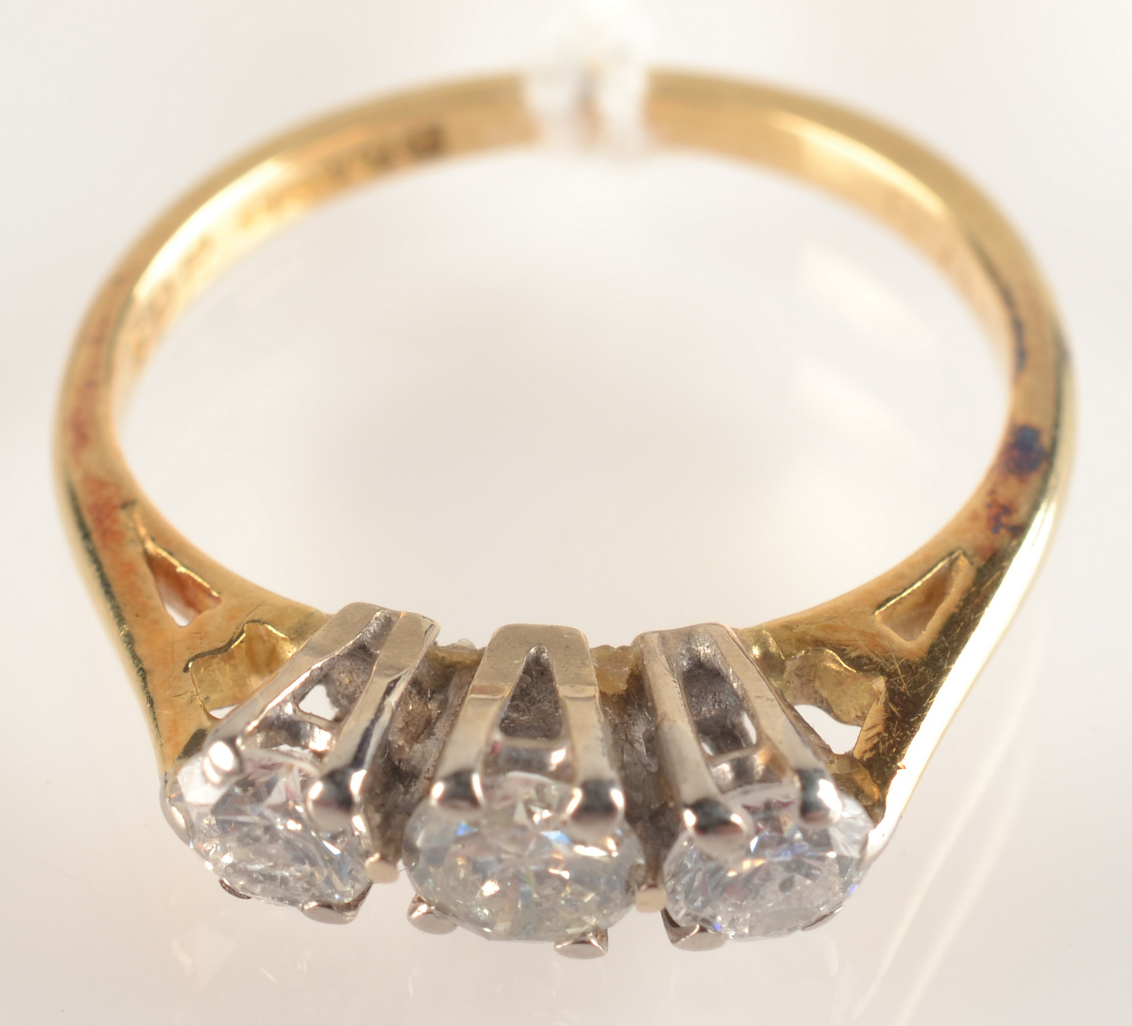 An 18 ct. gold three stone diamond ring.