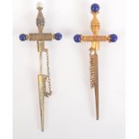 Two cannetille work sword and scabbard pins each mounted with lapis.