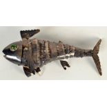 An eastern articulated fish with green glass eyes, length 16.5cm.