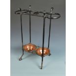 An Art Nouveau cast iron stick stand by Benson with two copper trays,