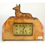 A continental Art Deco mantle clock with metal Alsatian sculpture to the top.