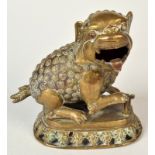 A Chinese metal incense burner cast as a Dog of Fo on a pierced oval base, height 17cm.