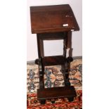 A Victorian gothic oak book rest with a folding kneeler step, height 68cm.