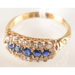 An 18ct. gold Victorian style ring set with sapphires within a band of diamonds.