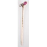 An unusual gold stick pin set a white diamond, a central brown pink diamond and a ruby, boxed.