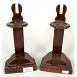 A pair of weighted mahogany cup and saucer stands, each with carved borders.